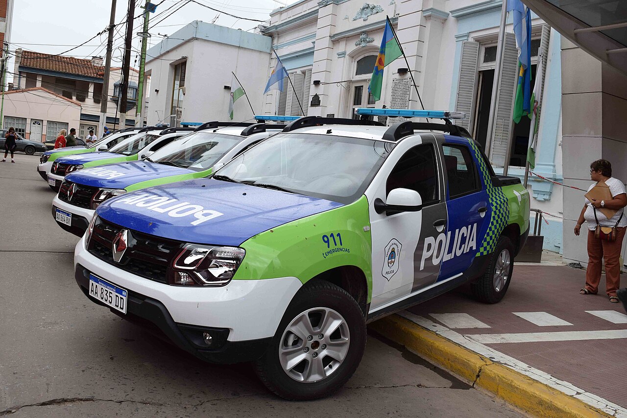 Patrulleros blancos, azules y verdes de la Policía de la Provincia de Buenos Aires estacionados en una calle